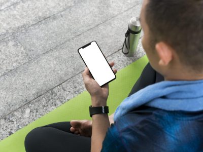 man-checking-smartphone-before-doing-some-yoga